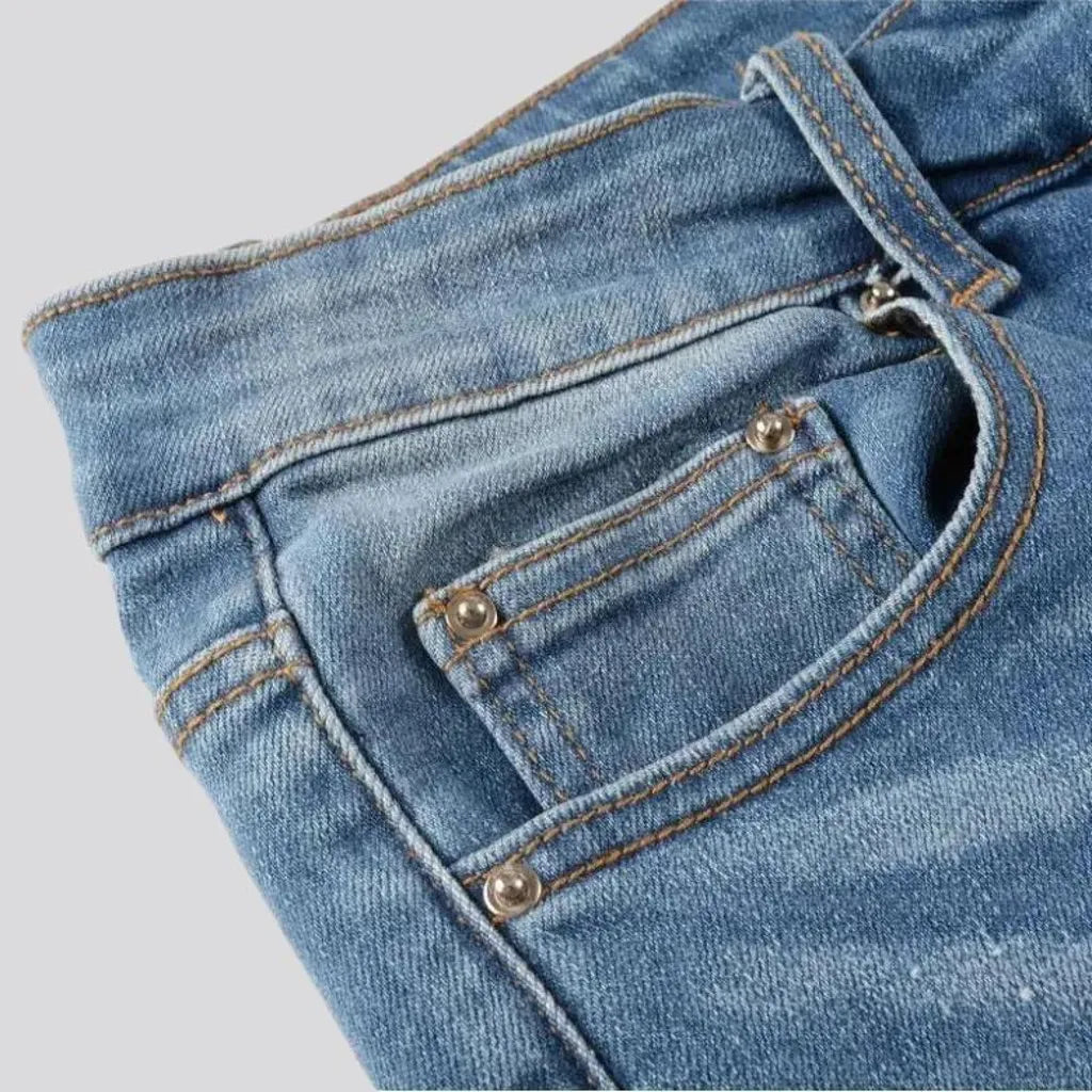 Damaged men's whiskered jeans