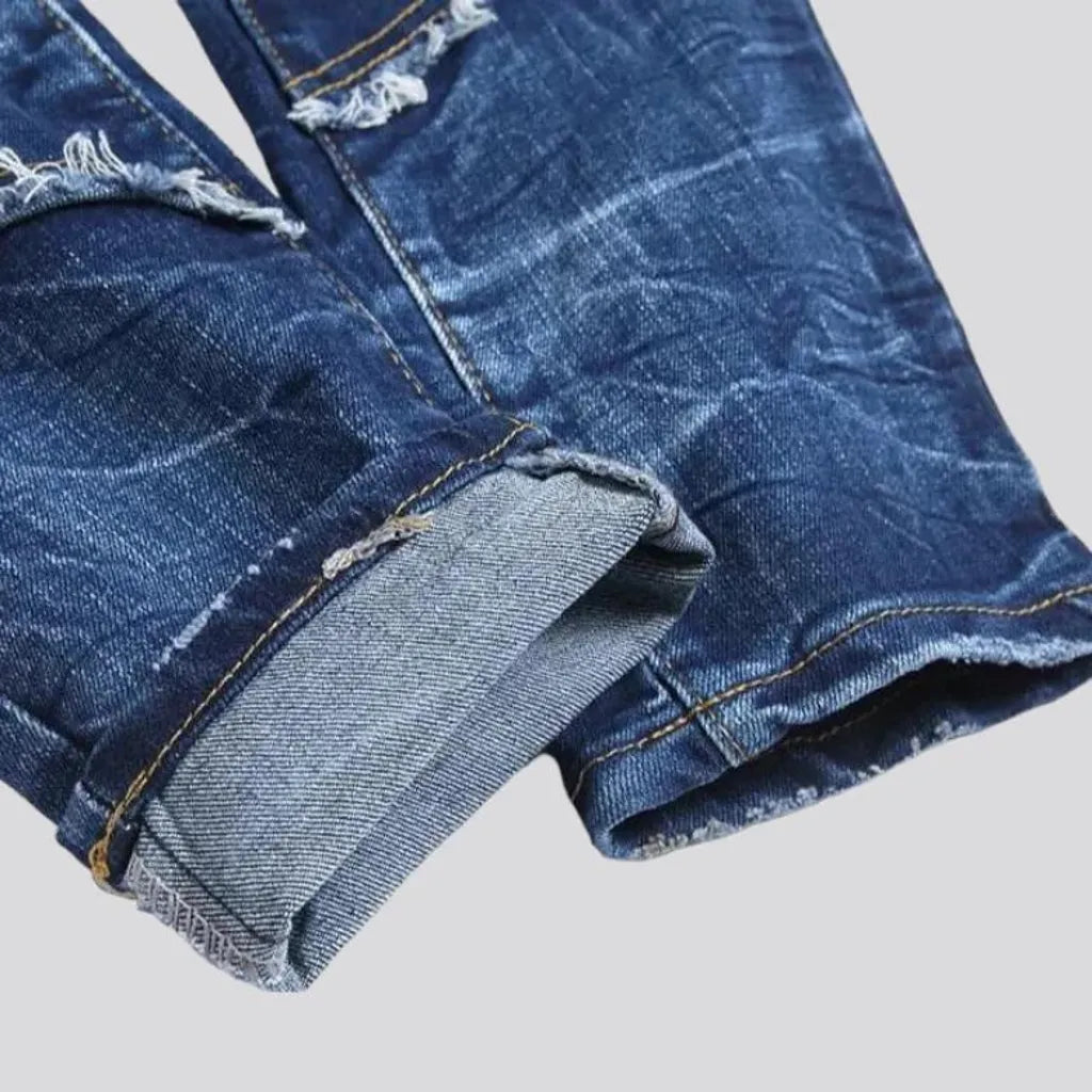 Damaged men's mid-waisted jeans