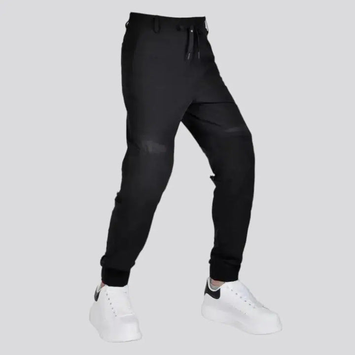 Black joggers riding denim pants