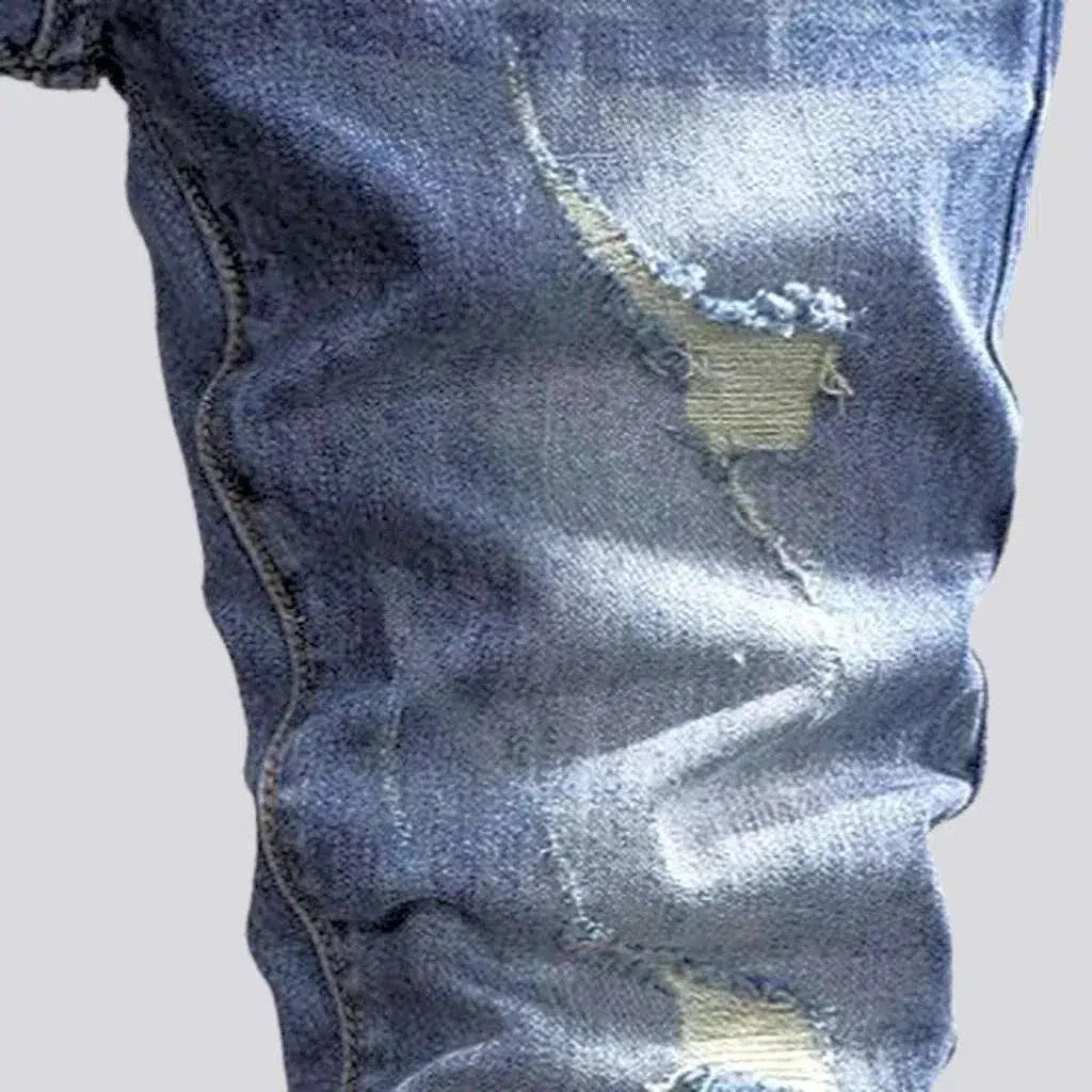 Sanded men's distressed jeans