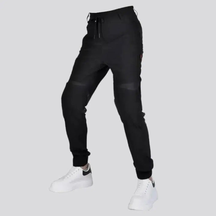 Black joggers riding denim pants