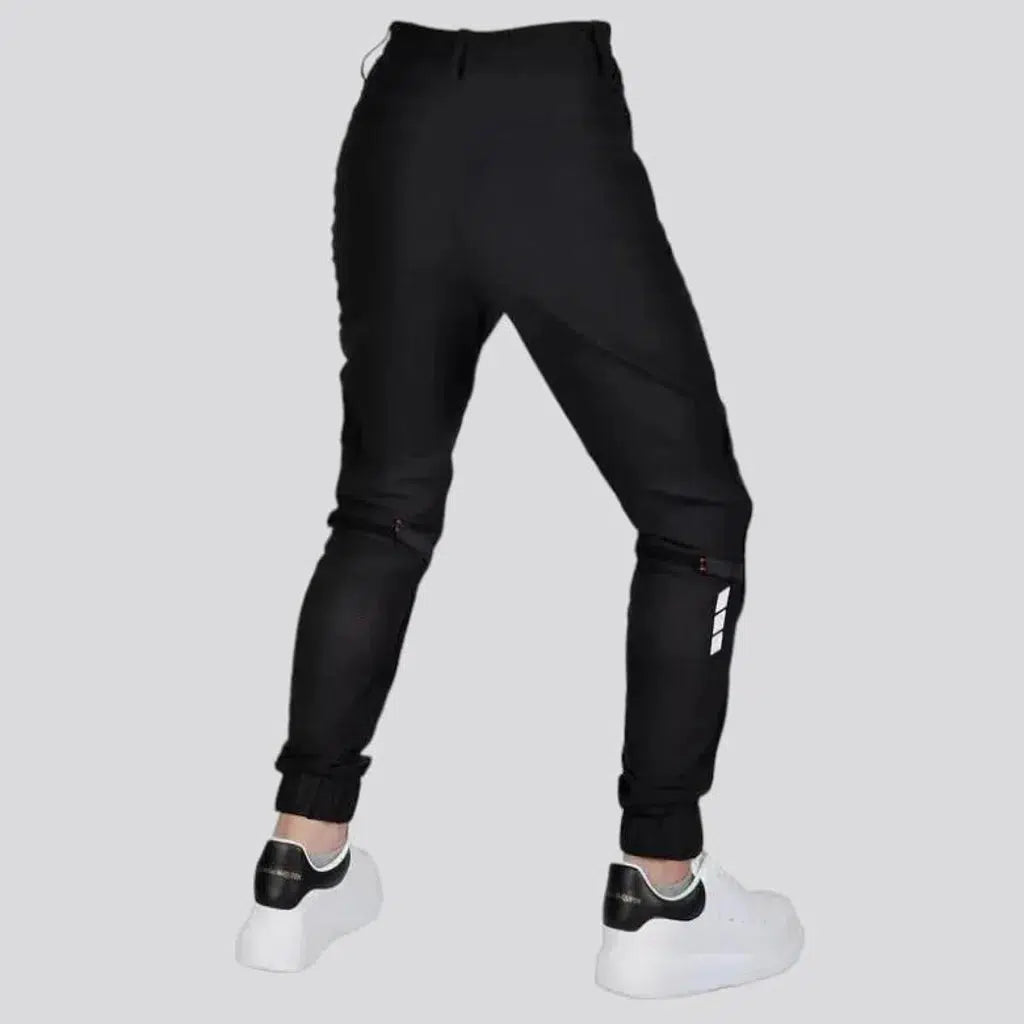 Black joggers riding denim pants