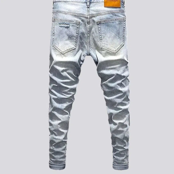 Sanded men's distressed jeans