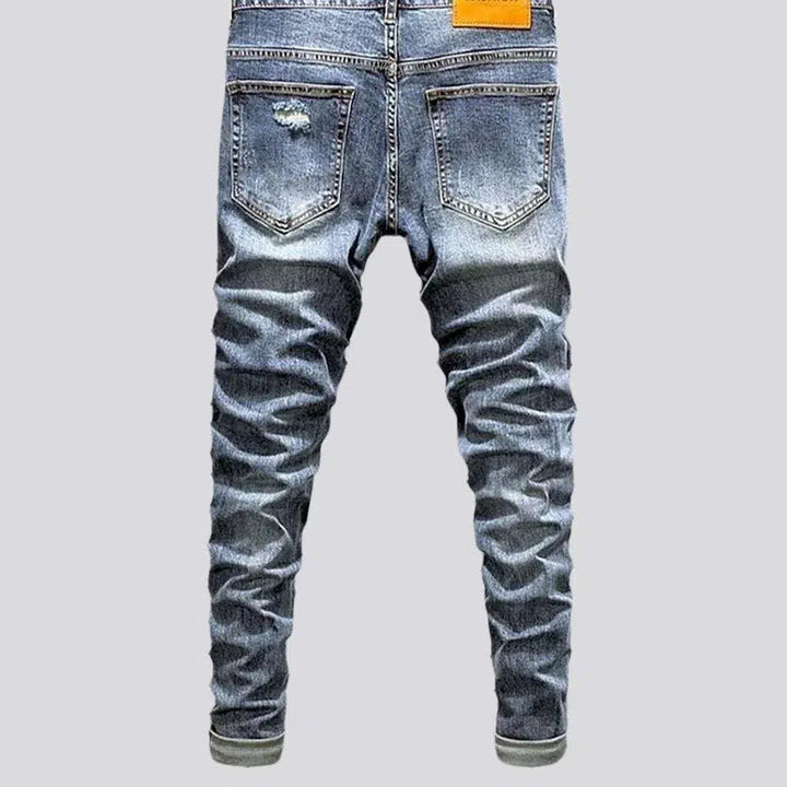 Sanded men's distressed jeans