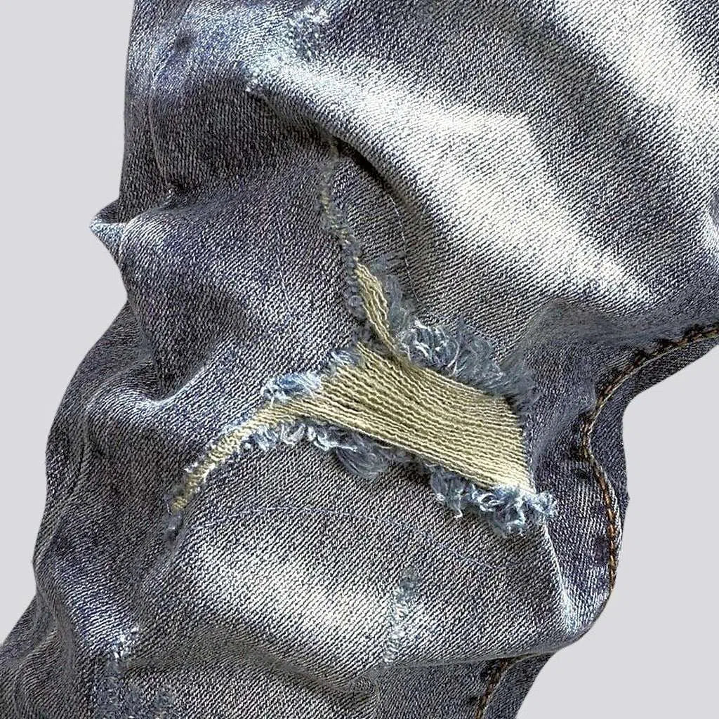 Sanded men's distressed jeans